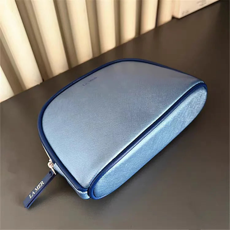 Bolsa de viaje portátil azul marino, una bolsa de mano de material PU de color puro, bolsa de almacenamiento fácil de llevar para artículos personales