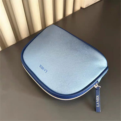 Bolsa de viaje portátil azul marino, una bolsa de mano de material PU de color puro, bolsa de almacenamiento fácil de llevar para artículos personales